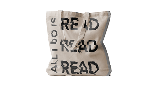 A canvas tote bag with black lettering that says ALL I DO IS READ READ READ
